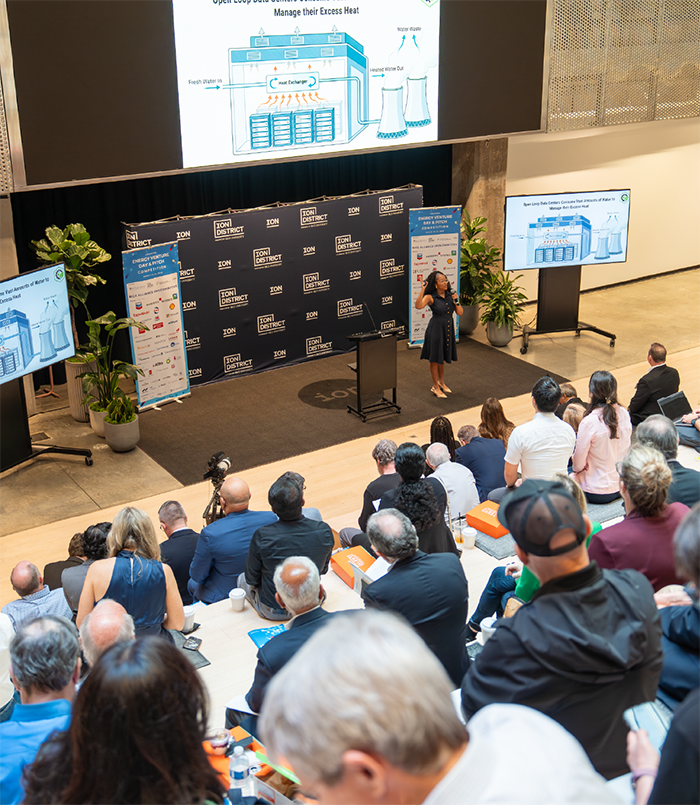 Person giving a presentation in front of a crowd